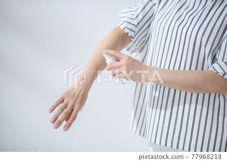 Senior woman sunscreen insect repellent at hand Senior woman sunscreen insect repellent at hand 77968218