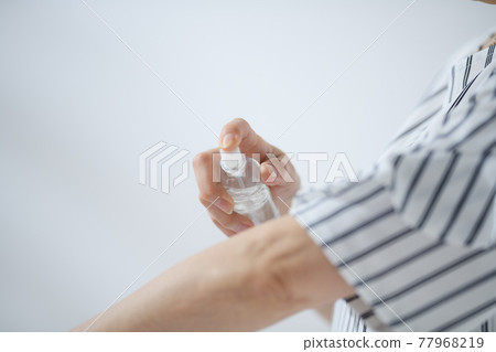 Senior woman sunscreen insect repellent at hand Senior woman sunscreen insect repellent at hand 77968219