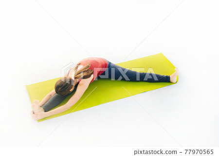 Side view portrait of beautiful young woman doing yoga or pilates exercise on white background Side view portrait of beautiful young woman doing yoga or pilates exercise on white background 77970565