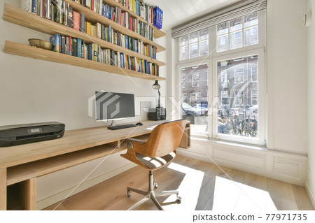 Home office with wall mounted table and bookshelves 77971735