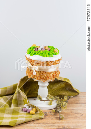 Easter cake made from yeast dough, decorated with edible moss with a nest Easter cake made from yeast dough, decorated with edible moss with a nest 77972846