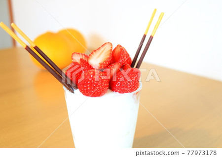 Panna cotta full of dessert strawberries 77973178