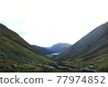 Asulwater peeking through a valley in the Lake District, England 77974852