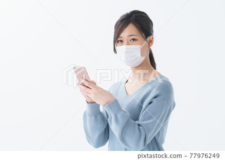 Female mask phone indoors Female mask phone indoors 77976249