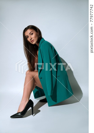 Stylish woman in blazer and high heels 77977742