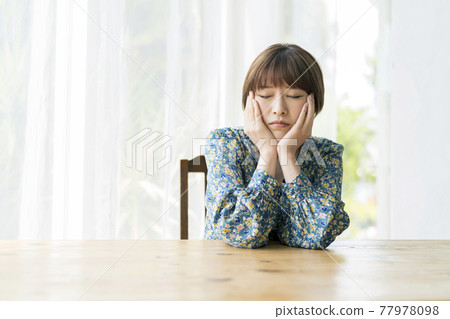 A young woman with a cheek stick and closed eyes A young woman with a cheek stick and closed eyes 77978098