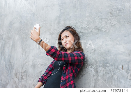 Young beauty hipster girl make selfie outdoor portrait on brick wall, vintage, grunge. 77978144