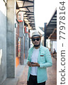 Hipster man listening music with his smartphone on the street in urban. 77978164