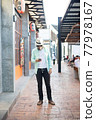 Hipster man listening music with his smartphone on the street in urban. 77978167