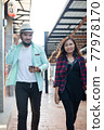 Young couple walking together on urban street. Couple in love concept. 77978170