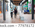 Young couple walking together on urban street. Couple in love concept. 77978172