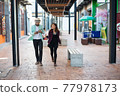 Young couple walking together on urban street. Couple in love concept. 77978173