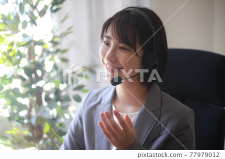 Female employee making a video call Female employee making a video call 77979012