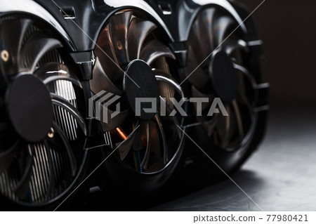 Video card with a cooling system with copper pipes, aluminum radiators and fans, Selective Focus 77980421