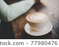 Man with coffee cup in cafe. 77980476