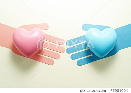 Image of gender equality. A hand with a pink heart and a hand with a blue heart next to each other. 77981004