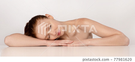 Shirtless Ginger-Haired Young Woman Sleeping Posing Over White Background Shirtless Ginger-Haired Young Woman Sleeping Posing Over White Background 77981620