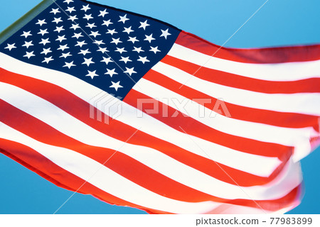 Waving usa flag against blue sky Waving usa flag against blue sky 77983899