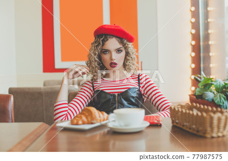 Dating. Woman french model in the cafeteria 77987575