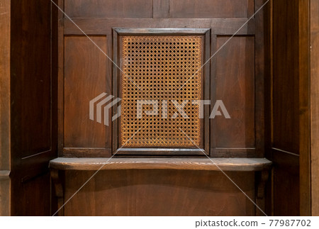 Wooden confessional from parishioner point of view 77987702