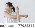 Women stretching against a white wall Fitness Beauty 77988248
