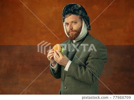 Portrait of red headed and bearded man playing famous artist isolated over dark bacground. Eras comparison Portrait of red headed and bearded man playing famous artist isolated over dark bacground. Eras comparison 77988709