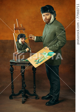 Portrait of red headed and bearded man playing famous artist isolated over dark bacground Portrait of red headed and bearded man playing famous artist isolated over dark bacground 77988711