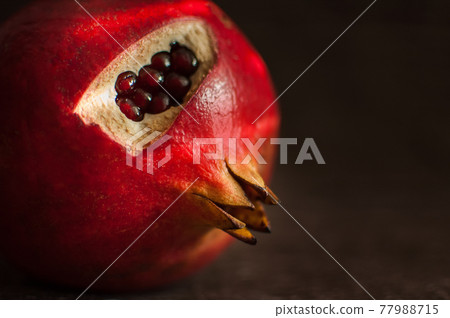 Juicy garnet, ripe pomegranate fruit on wooden background. Juicy garnet, ripe pomegranate fruit on wooden background. 77988715