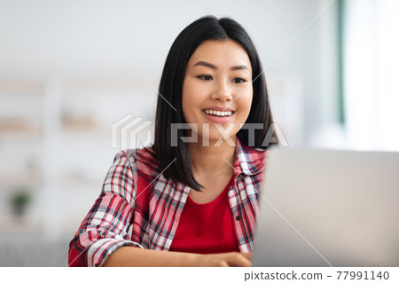Online Education. Happy young asian woman study with laptop at home 77991140