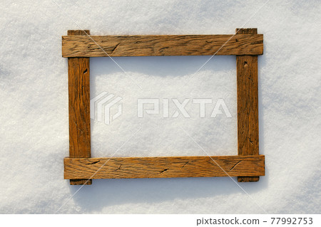 wooden frame on natural snow, copy-space background wooden frame on natural snow, copy-space background 77992753