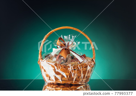 gift basket on emerald background gift basket on emerald background 77993377