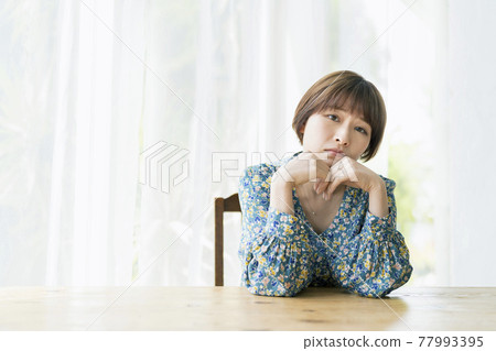 A young woman with a troubled expression on her cheeks 77993395