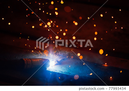 artistic welding sparks light, industrial background 77993434