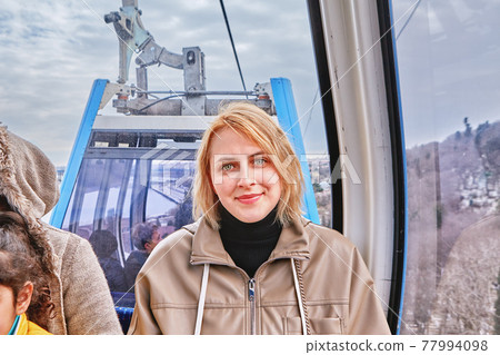 Funicular or cable car line of Istanbul from Eyup Sultan area to Piyer Loti hill white woman sits in cabin. Funicular or cable car line of Istanbul from Eyup Sultan area to Piyer Loti hill white woman sits in cabin. 77994098