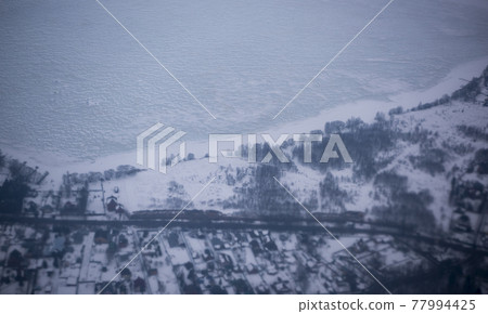 View of the snow-covered suburbs of Moscow from an airplane 77994425