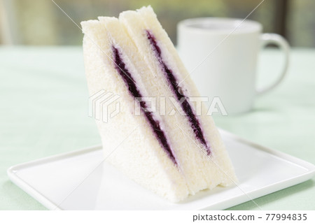 Delicious blueberry jam and cream sandwich (triangular sandwich) and coffee Delicious blueberry jam and cream sandwich (triangular sandwich) and coffee 77994835