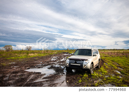 Mitsubishi Pajero/Montero at dirt road after rain 77994988