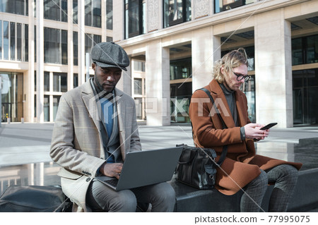 Businessmen working in the city Businessmen working in the city 77995075