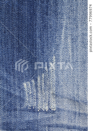 Blue torn denim jeans texture 77996974
