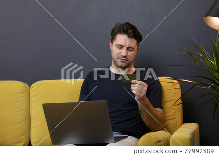 guy makes purchases or payments online, looks at credit card cvv security code guy makes purchases or payments online, looks at credit card cvv security code 77997389