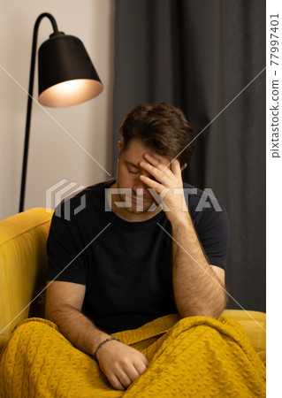 Depressed unshaven guy suffering from depression on sofa. mental illness, stress 77997401