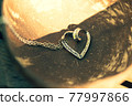 Heart pendant necklace on wood symbol of love Romance Valentine's Day Closeup. Selective Focus 77997866