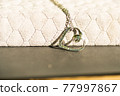 Heart pendant necklace on wood symbol of love Romance Valentine's Day Closeup. Selective Focus 77997867