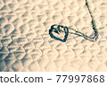 Heart pendant necklace on wood symbol of love Romance Valentine's Day Closeup. Selective Focus 77997868