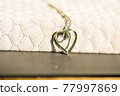 Heart pendant necklace on wood symbol of love Romance Valentine's Day Closeup. Selective Focus 77997869
