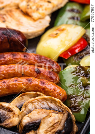 Grilled sausages, meat, and vegetables. Grilled sausages, meat, and vegetables. 77997997