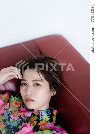 Genderless LGBT woman lying on the sofa 77998086