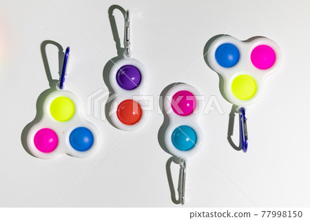 Simple Dimple Fidget toy, colorful anti-stress game isolated on white background Simple Dimple Fidget toy, colorful anti-stress game isolated on white background 77998150