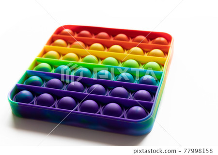 Pop It anti-stress Fidget toy, colorful rainbow game isolated white background Pop It anti-stress Fidget toy, colorful rainbow game isolated white background 77998158