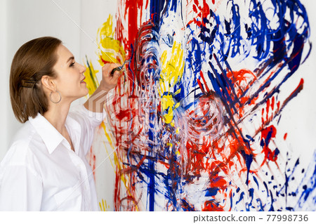 art therapy artist woman painting colorful wall 77998736